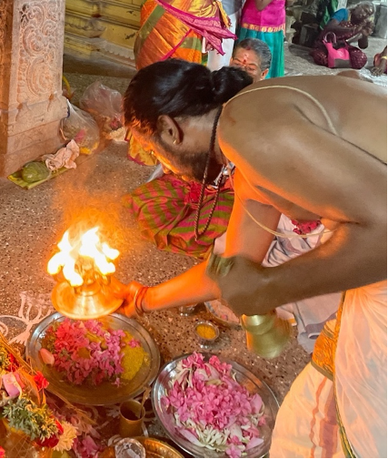 Priest with bell and deepam